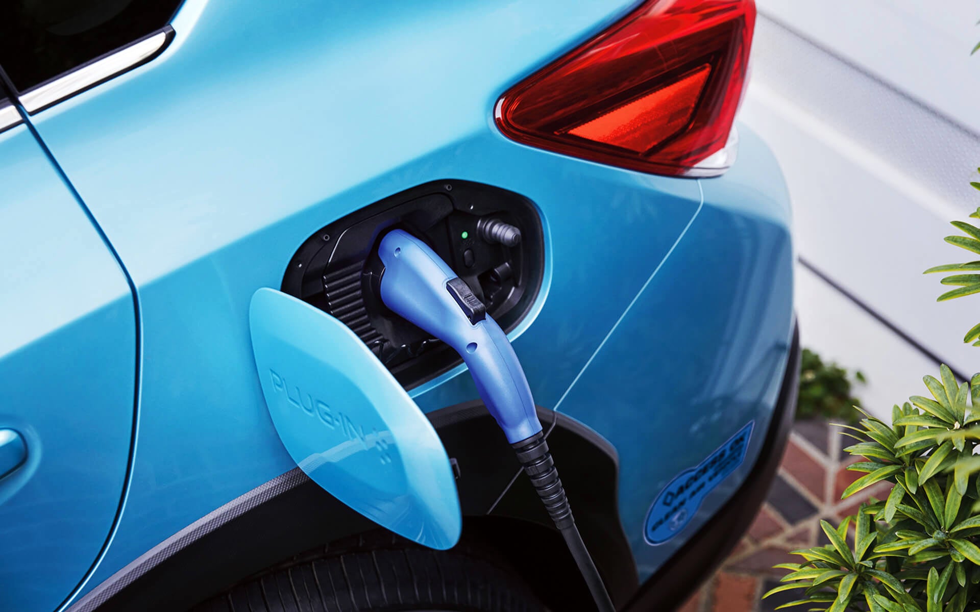 A close-up of the Subaru Crosstrek Hybrid's charging port with charging cable plugged in | Five Star Subaru in Grapevine TX