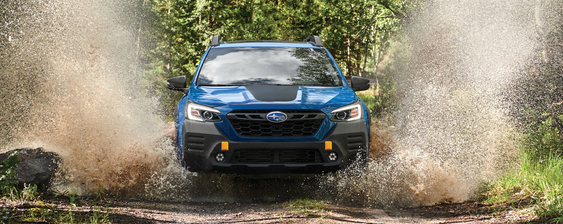 A 2023 Outback Wilderness driving on a muddy trail. | Five Star Subaru in Grapevine TX